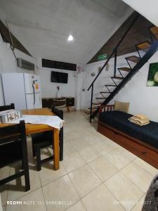 a room with a table and a bed and a staircase at Bruna Zona Alta in San Fernando del Valle de Catamarca +25 photos