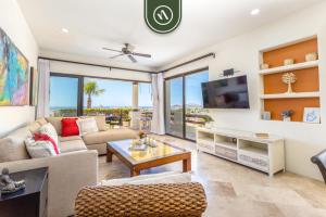 ein Wohnzimmer mit Sofa und Fernseher in der Unterkunft New 2 BR Condo in San Jose - Pool - Tennis in San José del Cabo