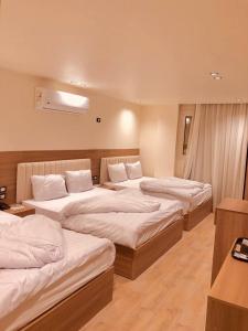 a hotel room with three beds in a room at Amigo de Las pirámides in Cairo +58 photos