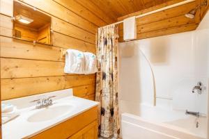 a bathroom with a sink and a toilet and a tub at Above it All・3 Mi to Dollywood・Hot Tub・Pool Table・Pet Friendly in Pigeon Forge +35 photos