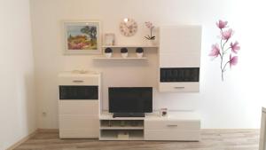 a living room with a tv and white cabinets at Apartment Soric in Senj
