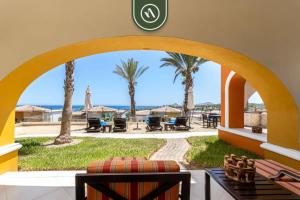 a view from the living room of a resort with palm trees at 2BR House with Ocean View in Cabo in El Tule