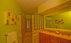 a bathroom with a sink and a large mirror at Las Mañanitas LM E3303 in San José del Cabo +13 photos