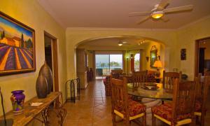 a living room with a table and a dining room at Las Mañanitas LM E3303 in San José del Cabo