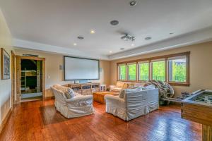 a living room with two couches and a large screen at Mountain Estate Main House in Newry