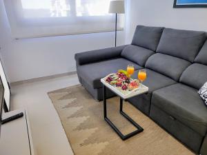 a living room with a couch and a table with drinks at Korner in Adeje