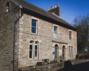 an old brick building with windows and a roof at Dacre House, Gilsland in Gilsland