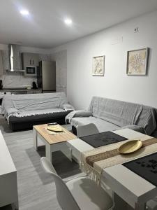 a living room with a couch and a table at Apartamento El Rincón del Olivar III in Montoro