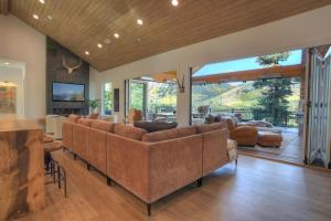 a living room with leather furniture and a large window at 2001 Lake Purgatory Drive in Durango