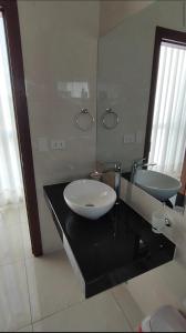 a bathroom with a sink and a mirror at Arena Cielo y Mar in Santa Cruz de la Sierra +38 photos