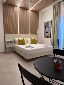 a bedroom with a large bed and a table at Conte Luxury Rooms in Salerno +24 photos