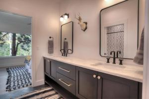 a bathroom with two sinks and two mirrors at 2001 Lake Purgatory Drive in Durango +60 photos