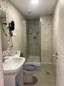 a bathroom with a toilet and a sink and a shower at Chillout 10, Granada centro in Granada +42 photos