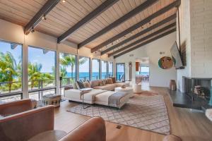 a living room with a couch and a fireplace at Socal Style in Encinitas