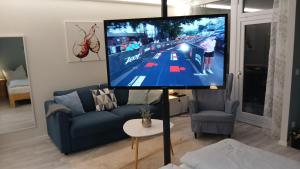 a television on a pole in a living room at Auszeit am Steinhudermeer in Steinhude