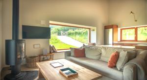 a living room with a couch and a fireplace at Cabaña Quieva 02 in Rubalcaba