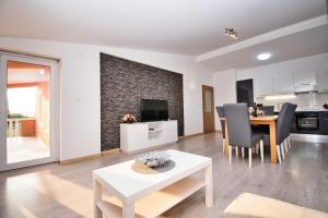 a living room with a table and a dining room at MY DALMATIA - Apartment Visocane with private pool in Visočane