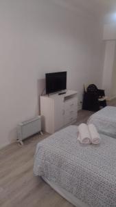 a bedroom with two twin beds and a television at Hermoso Departamento En El Centro De Buenos Aires in Buenos Aires