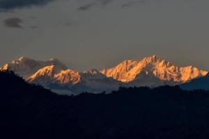 a group of mountains with the sun shining on them at Walk in the Himalayas in Pelling