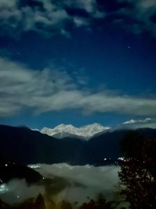 a view of a valley with snow capped mountains at Walk in the Himalayas in Pelling
