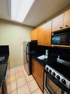 a kitchen with a black refrigerator and a microwave at Silver Seas Beach Resort in Fort Lauderdale +30 photos