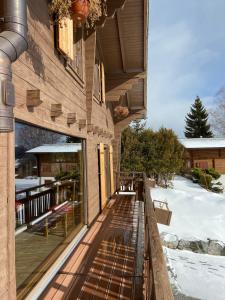 a balcony of a house with snow on the ground at Chalet Beau-Site Anzère in Anzère