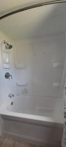 a white bath tub with a sink in a bathroom at Welcome to Bluebird Cottage in Lakeview +16 photos
