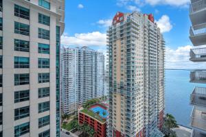 an aerial view of tall buildings next to the water at Lux condo on 25floor in Brickell in Miami