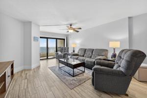 a living room with two couches and a table at New listing! Direct oceanfront with private balcony, pool, and hot tub in Bottle Island