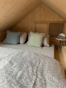 a bedroom with a bed with pillows on it at Posed Rikitan in Spálené Poříčí