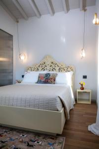 a bedroom with a large white bed in a room at Dimora Moncher in Montignoso +58 photos