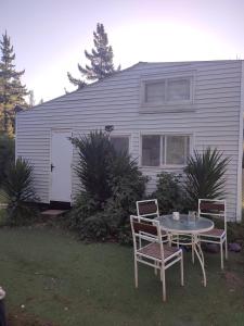 a table and chairs in front of a house at Eco good vibrations in Algarrobo