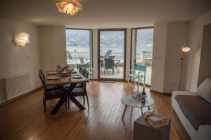 a living room with a table and a couch at Le Panoramique Rivage - Terrasse privative in Duingt