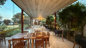 a restaurant with tables and chairs on a patio at Ville Real Hotel in Santo Antônio do Leite