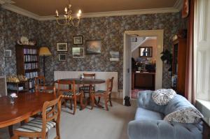 a living room with a table and a couch at Lower Bryanston Farm in Blandford Forum +21 photos