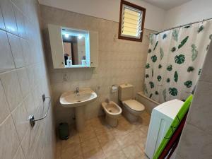 a bathroom with a sink and a toilet and a mirror at Beautiful Apartment Spectacular Terrace in Puerto de Santiago +22 photos