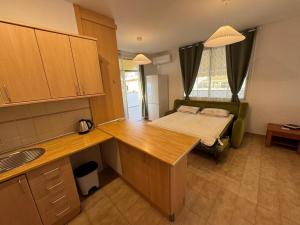 a room with a bed and a kitchen with a desk at Beautiful Apartment Spectacular Terrace in Puerto de Santiago