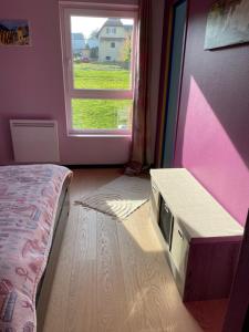 a bedroom with a bed and a window at Chez Nouchka 