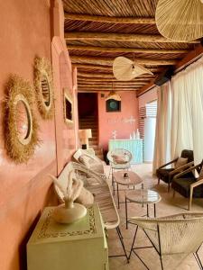 a living room with couches and tables and chairs at Riad Birdy, Charmant et privatif, Piscine, Rooftop, 6 suites, 2 salons, Wifi in Marrakesh