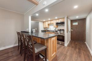 a kitchen with a island with chairs and a counter top at 107B One Bedroom One Bath in Thayerville +16 photos