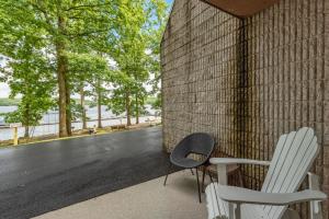 two chairs sitting on a porch next to a brick wall at 107B One Bedroom One Bath in Thayerville