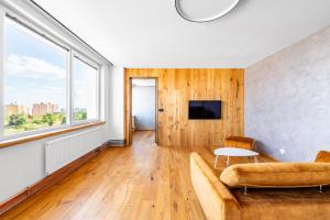 a living room with a couch and a table at Urban Oasis Stodůlky in Prague