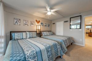 a bedroom with two beds and a ceiling fan at 508G Two Bedroom One Bath in Thayerville +18 photos