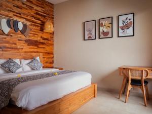a bedroom with a bed and a wooden wall at LM Home Mendira in Candidasa +36 photos