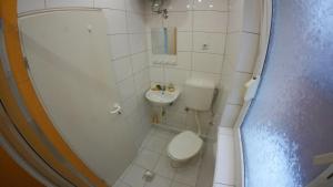 a small bathroom with a toilet and a sink at Cozy Quiet Apartment Nis in Niš +21 photos