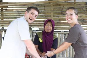 a group of three people standing next to each other at Stay Together in Tetebatu