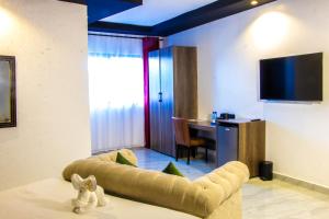 a living room with a couch and a table at Avian Court Hotel in Naivasha