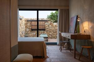 a room with a bed and a desk and a window at Resort Fontes Episcopi in Aragona +150 photos