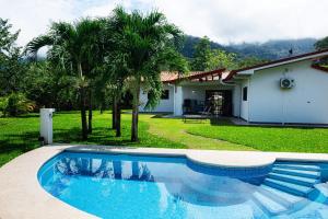 a swimming pool in front of a house at Sleeps 8large Poolgatedprivate Oasis Ojochal in Ojochal