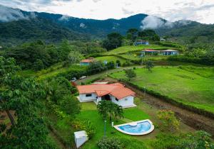 an aerial view of a house with a boat in a field at Sleeps 8large Poolgatedprivate Oasis Ojochal in Ojochal